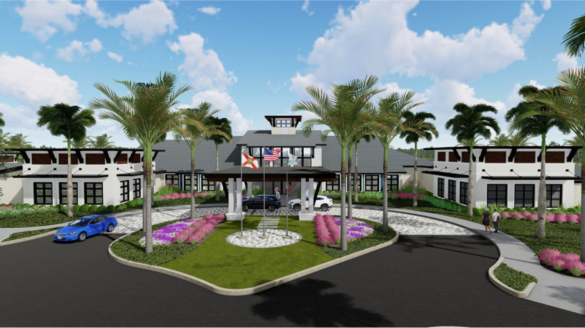 Resort entrance with circular driveway and palm trees